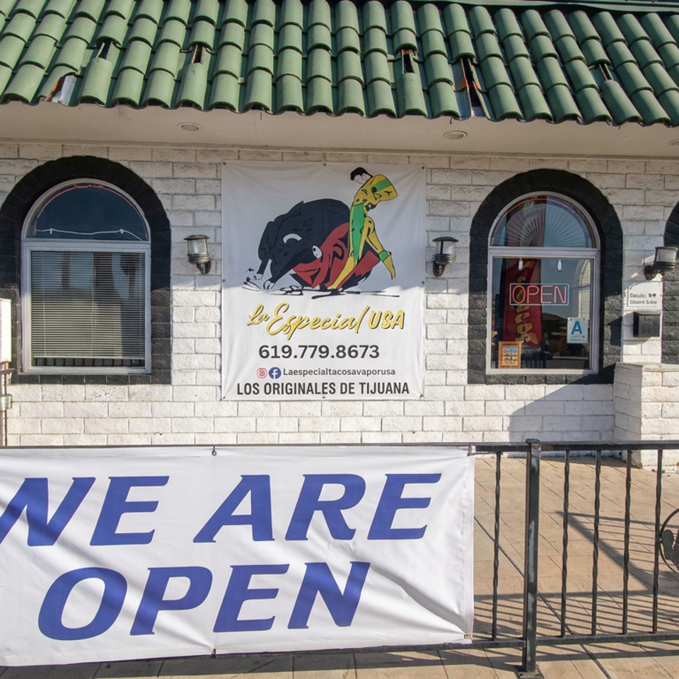 La Especial USA Tijuana restaurant storefront with green tiled roof, colorful logo banner, open sign, and large “We Are Open” banner.